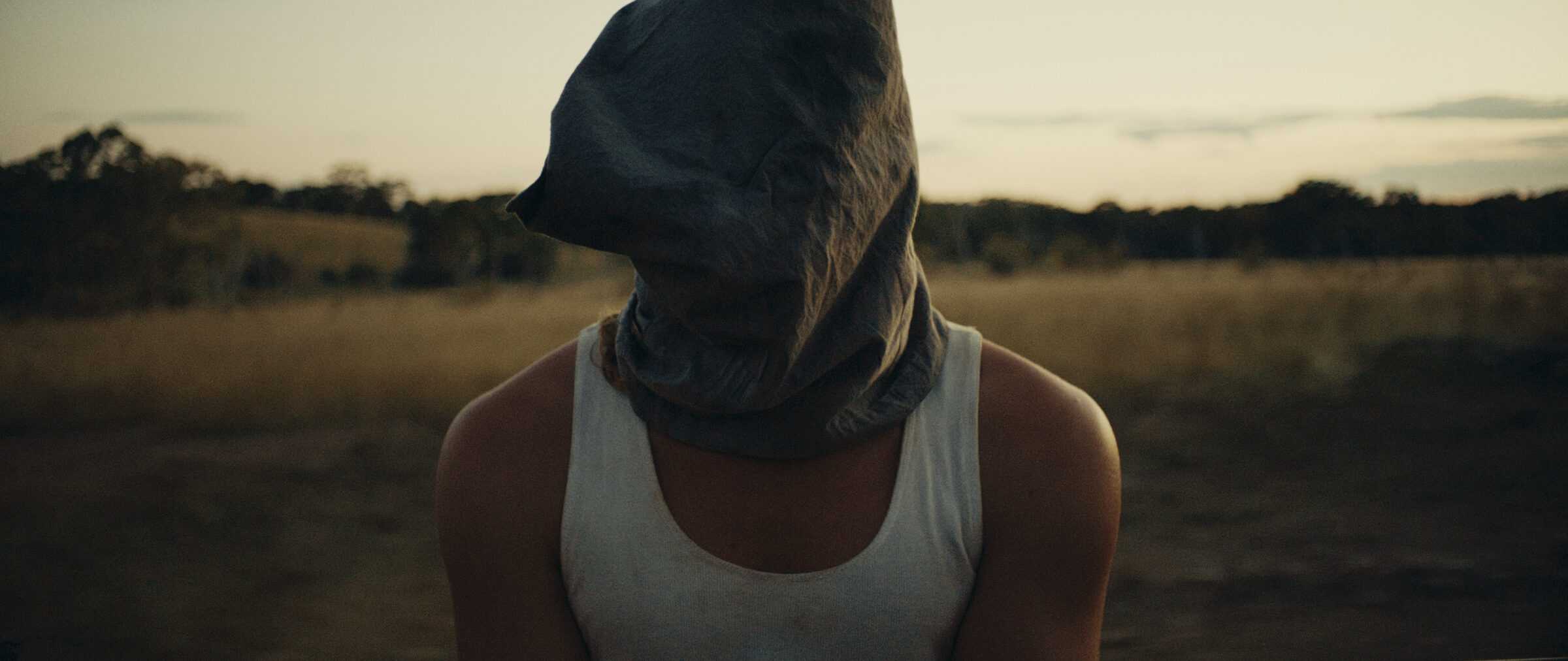 Strange Attractor — hooded figure at dusk